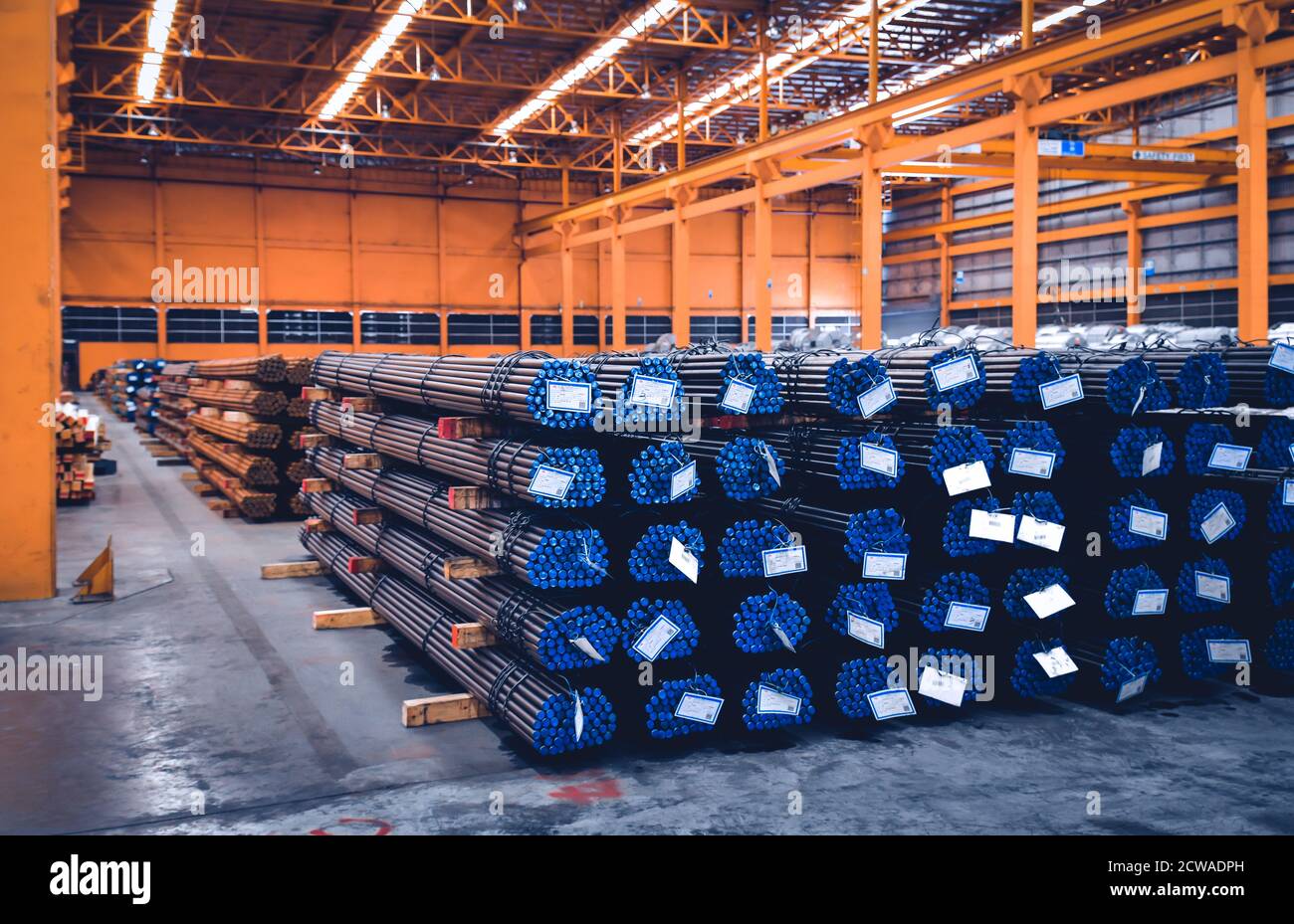 Pack of steel round bar stack in layer inside large distribution warehouse. Steel warehouse logistics operations. Stock Photo