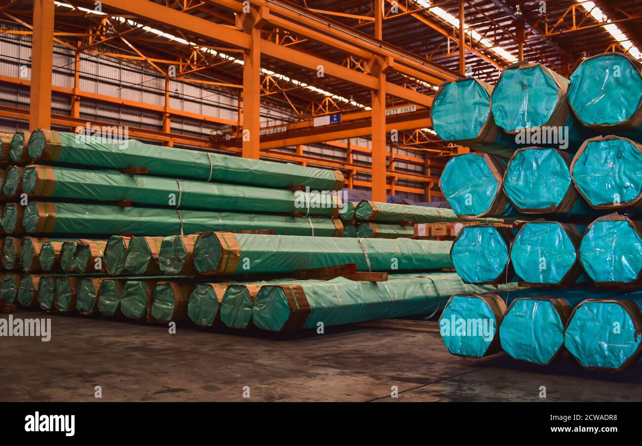 Pack of steel round bar stack in layer inside large distribution warehouse. Steel warehouse logistics operations. Stock Photo