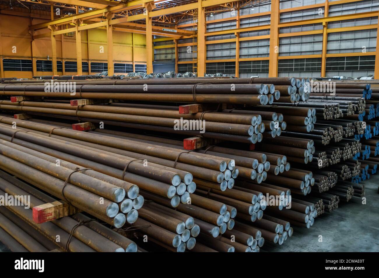 Steel round bar storage and stacking in a warehouse. Stock Photo