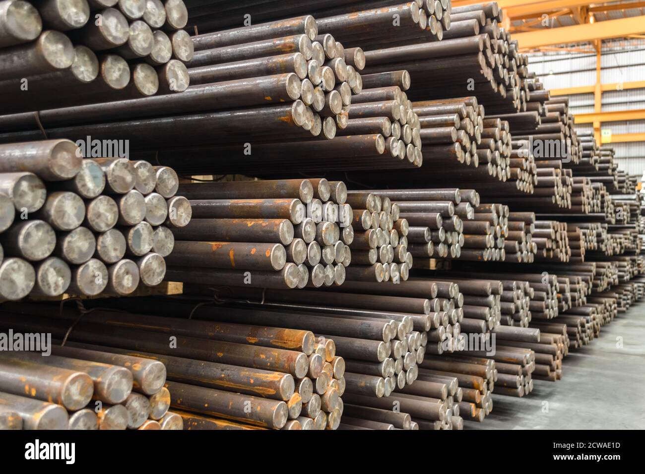 Steel round bar storage and stacking in warehouse. Stock Photo