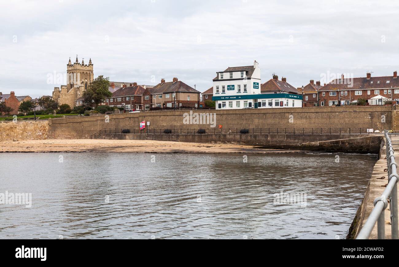 The seafront at the Headland,Hartlepool,England,UK with the Pot House pub and St Hildas Church in background Stock Photo