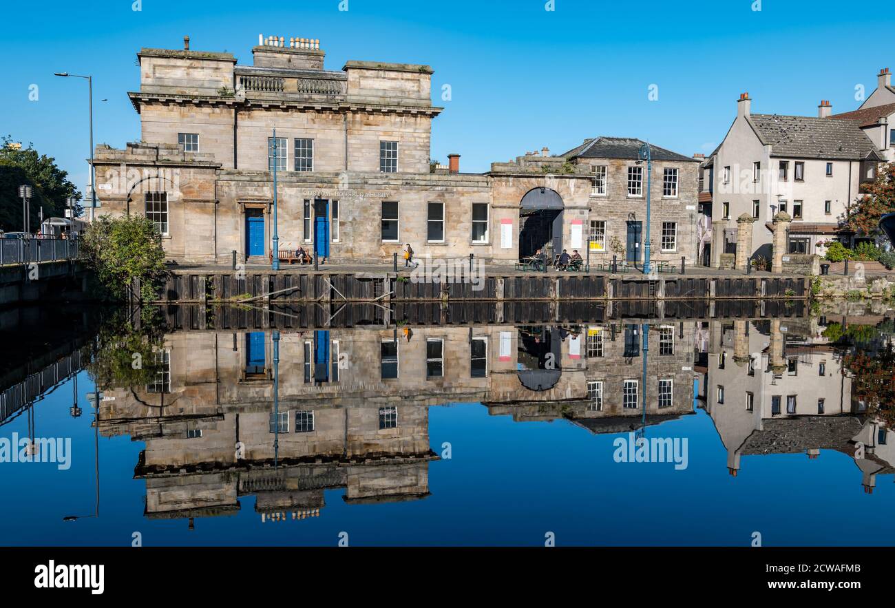 Leith, Edinburgh, Scotland, United Kingdom, 29th September 2020. UK Weather: sunshine on Leith. The sun really does shine on the Water of Leith and on a calm sunny day creates wonderful reflections in the water around The Shore with Leith Customs House reflected in the Water of Leith river Stock Photo