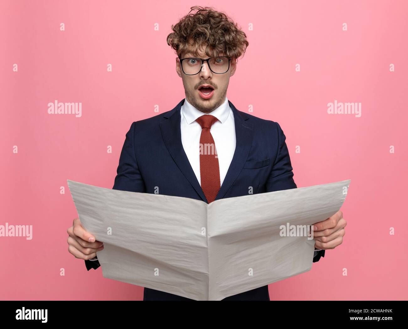 Shocked Young Man In Navy Blue Suit Wearing Glasses Reading Newspaper And Opening Mouth Posing On Pink Background Stock Photo Alamy Shocked Young Man In Navy Blue Suit Wearing Glasses Reading Newspaper And Opening Mouth Posing On Pink Background Stock Photo Alamy