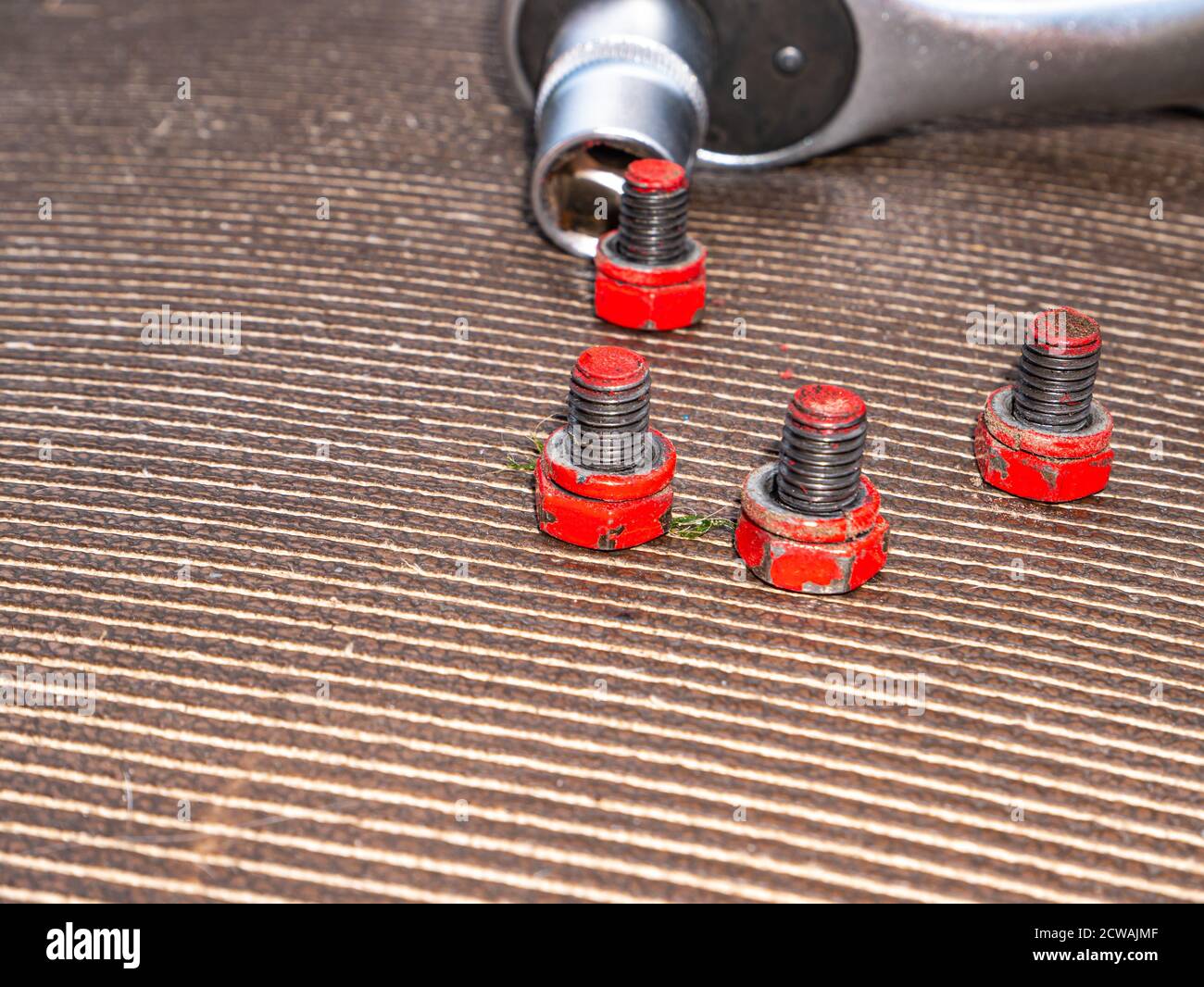 Bolts and nuts loosened with a socket wrench. Stock Photo