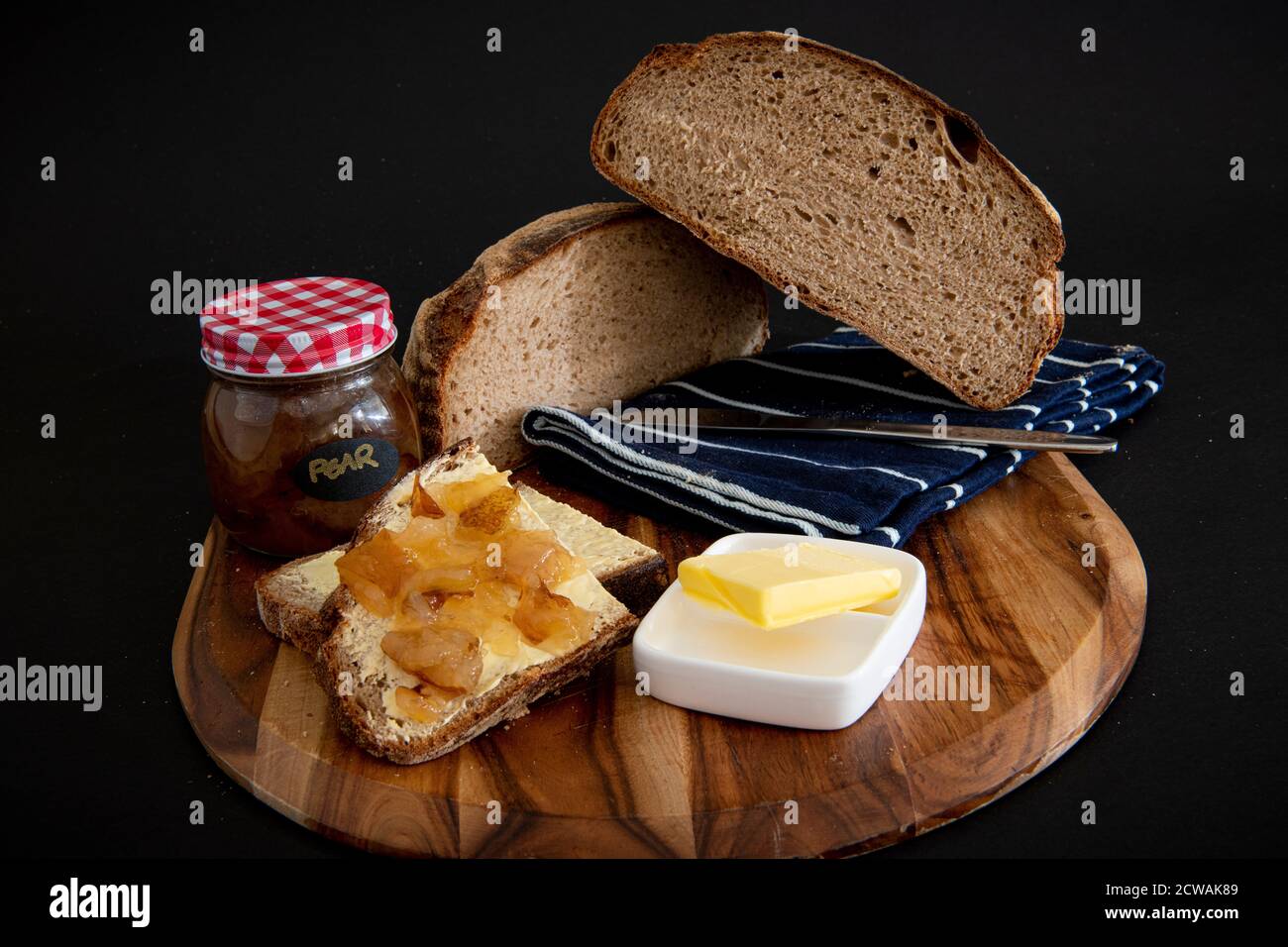 Rye bread on a wooden board with a black background Stock Photo