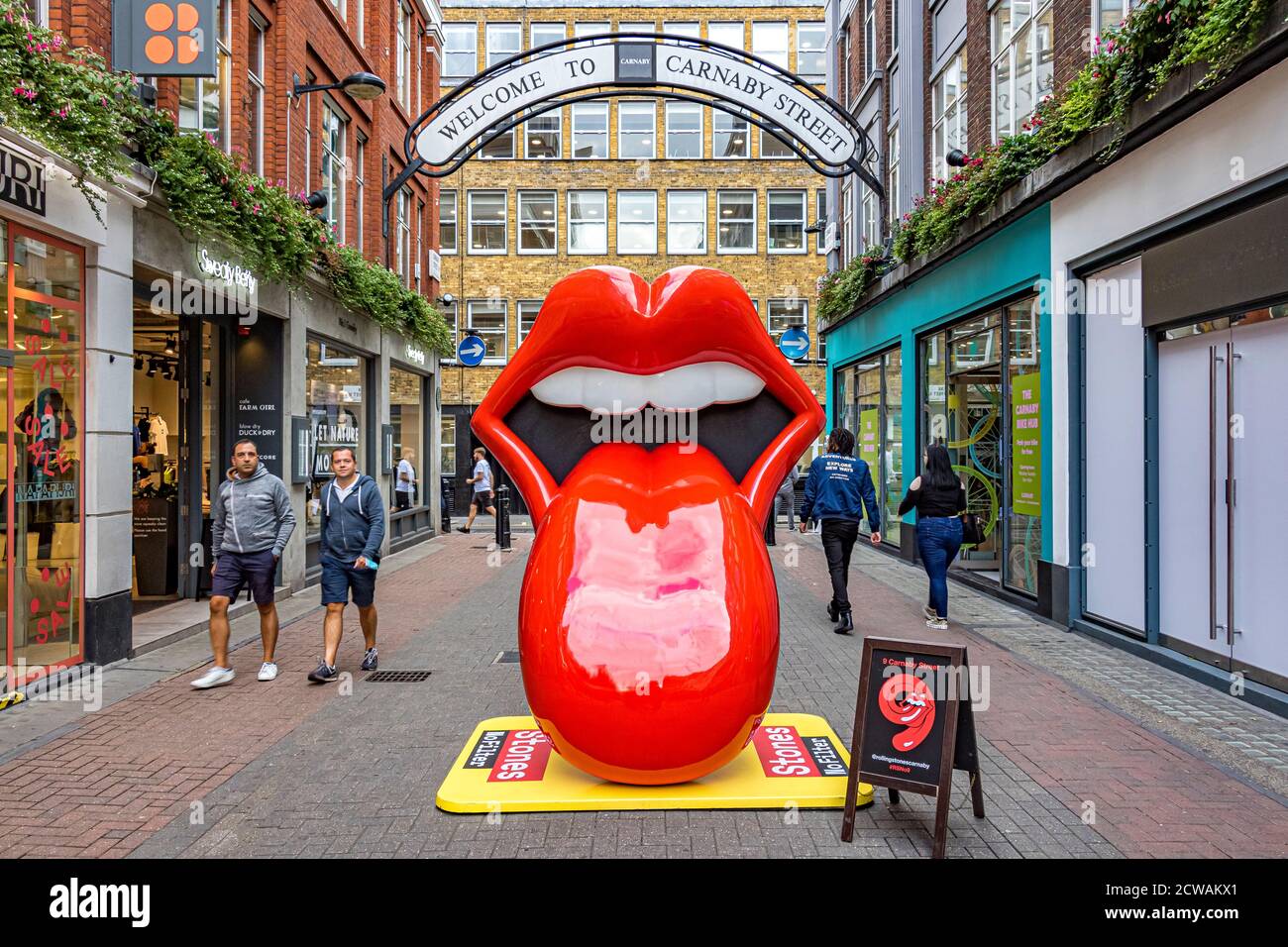 Rolling Stones tongue and lips logo in Carnaby Street, London where the worlds first Rolling Stones retail store, RS No. 9 Carnaby, has opened, London Stock Photo