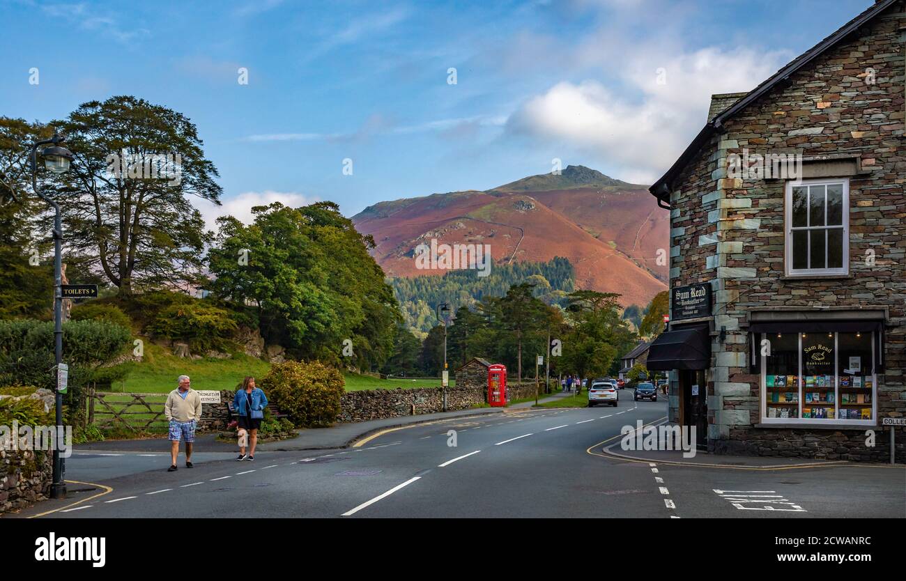View of shops in Grasmere with Hellvellyn mountain range in background in Grasmere, Lake District, Cumbria, UK on 21 September 2020 Stock Photo