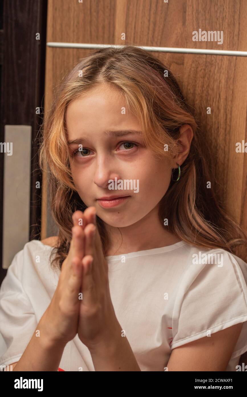 cute little kid is crying. Portrait of a sad child girl 9 or 10 years old. Teenager Stock Photo