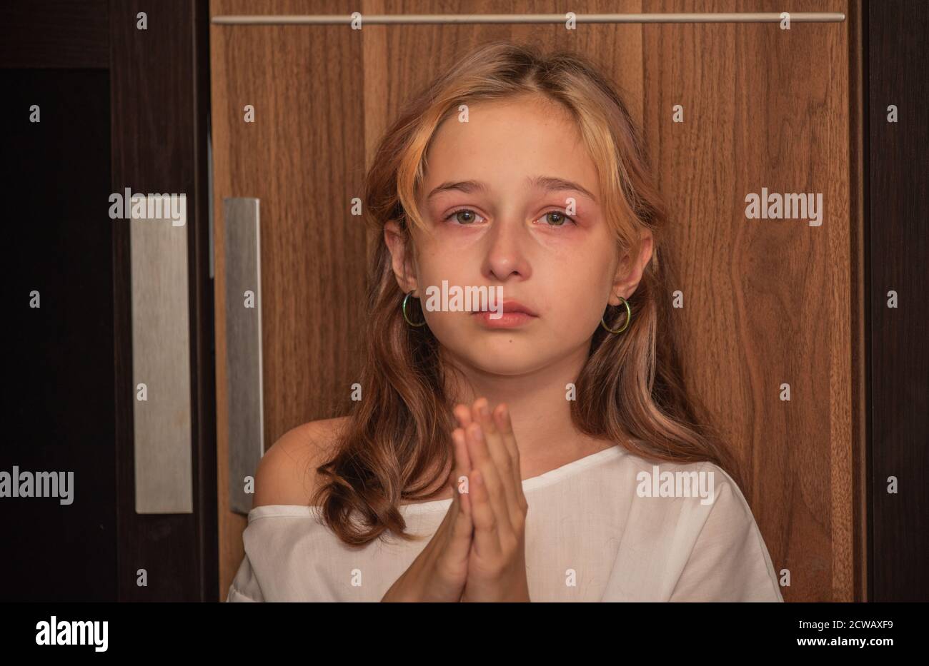 cute little kid is crying. Portrait of a sad child girl 9 or 10 years