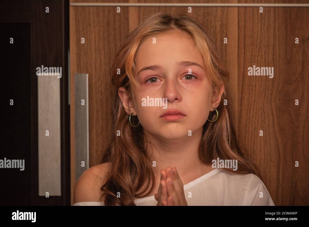 cute little kid is crying. Portrait of a sad child girl 9 or 10 years