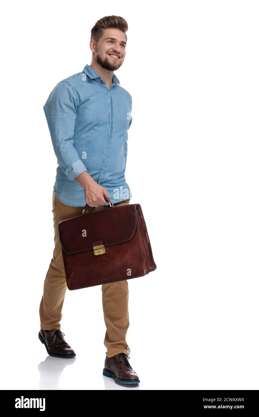 Cheerful casual man laughing while holding briefcase and stepping on ...