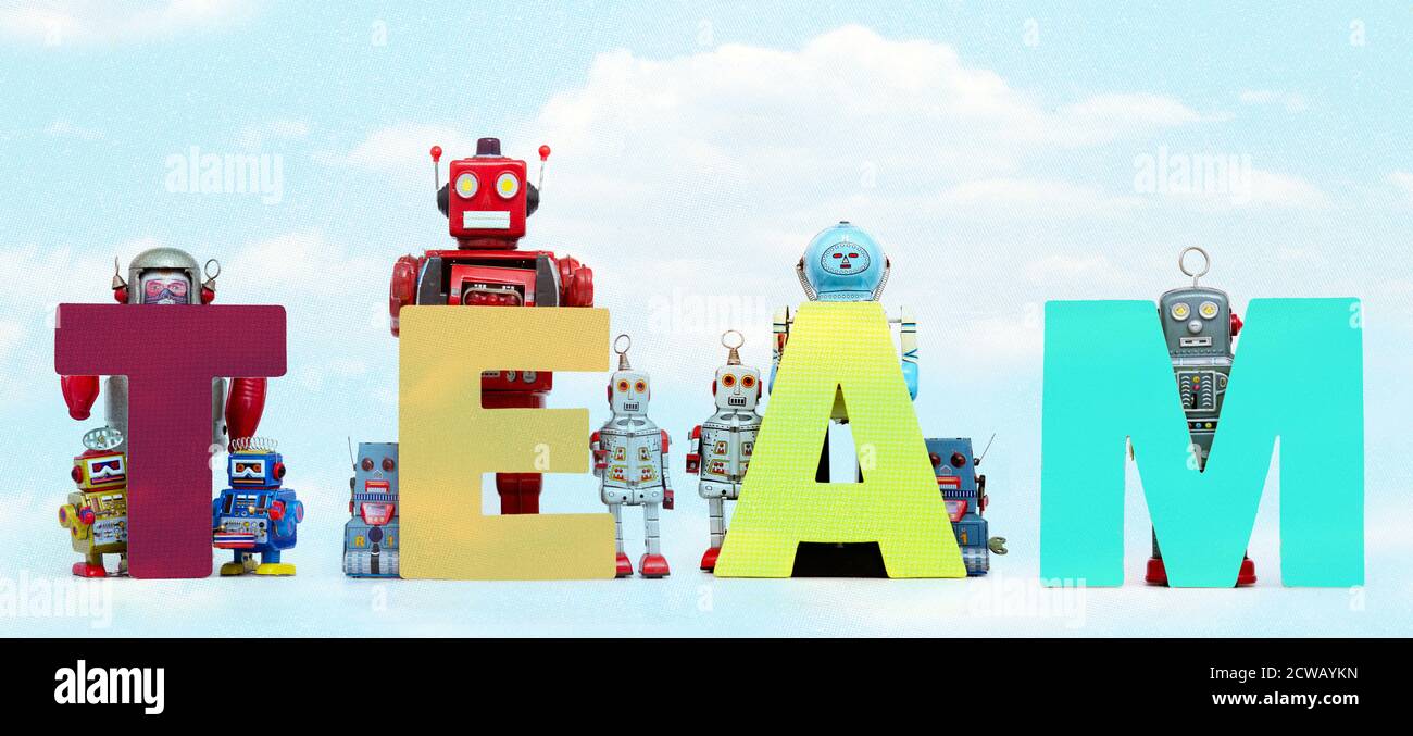 The word     TEAM  held by retro robots  cloud Stock Photo