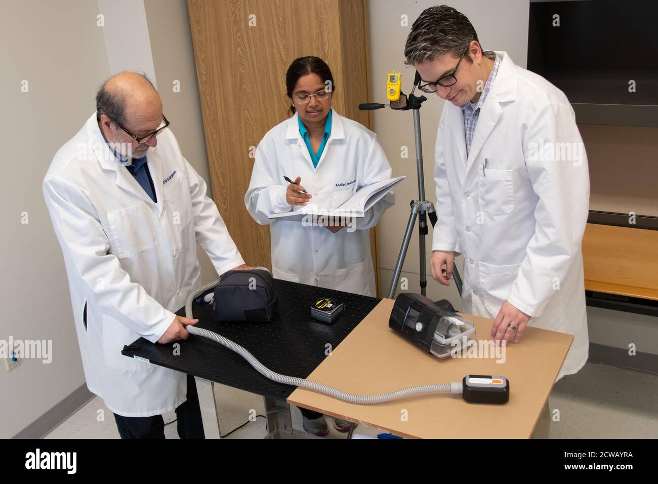 Testing CPAP Cleaning Devices - 2407 Using an ozone meter on a tripod, FDA scientists observe elevated ambient ozone levels while testing a device claiming to use ozone to clean Continuous Positive Airway Pressure (CPAP) machines. To date, ozone gas has not been proven to be safe or effective for this use. While cleaning your CPAP is important, most CPAPs can be cleaned safely and effectively with mild soap and water as described in the owner’s manual, with some manufacturers recommending the use of diluted vinegar.  Scientists from left to right: Oleg Vesnovsky, Ph.D., Lead General Engineer; Stock Photo