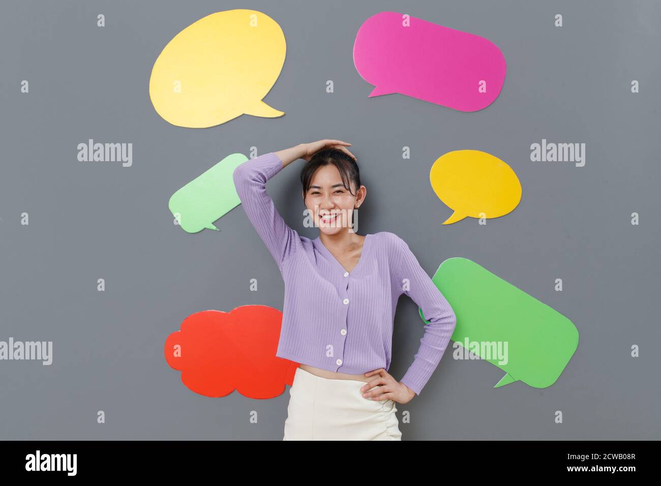 Happy girl standing in front of the dialog box Stock Photo - Alamy