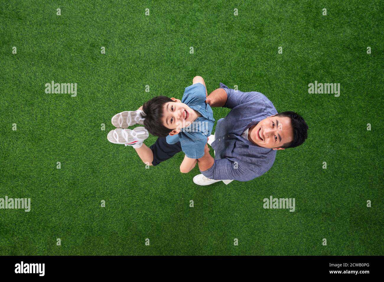 The happy father and son on the grass Stock Photo - Alamy
