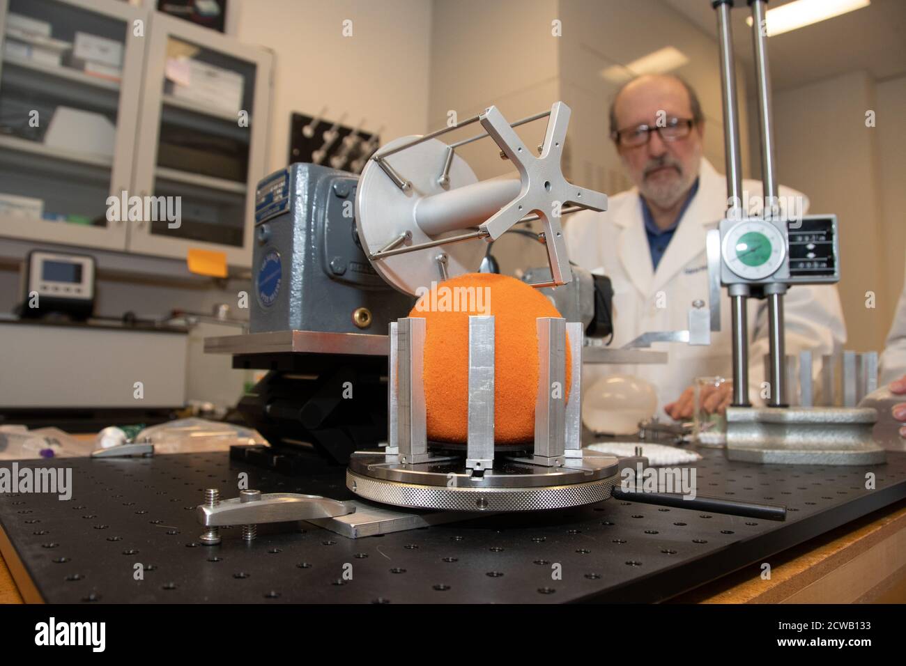 Intragrastric Balloon Leakage Testing - 2557 Oleg Vesnovsky, Ph.D., Lead General Engineer and Jean E. Rinaldi, MSBioE, Biomedical Engineer (not shown) in FDA's Center for Devices and Radiological Health prepare an intragastric balloon, used in the treatment of obesity, for leakage testing in a gastric motion simulator. The orange foam ball represents the position of the balloon. Stock Photo