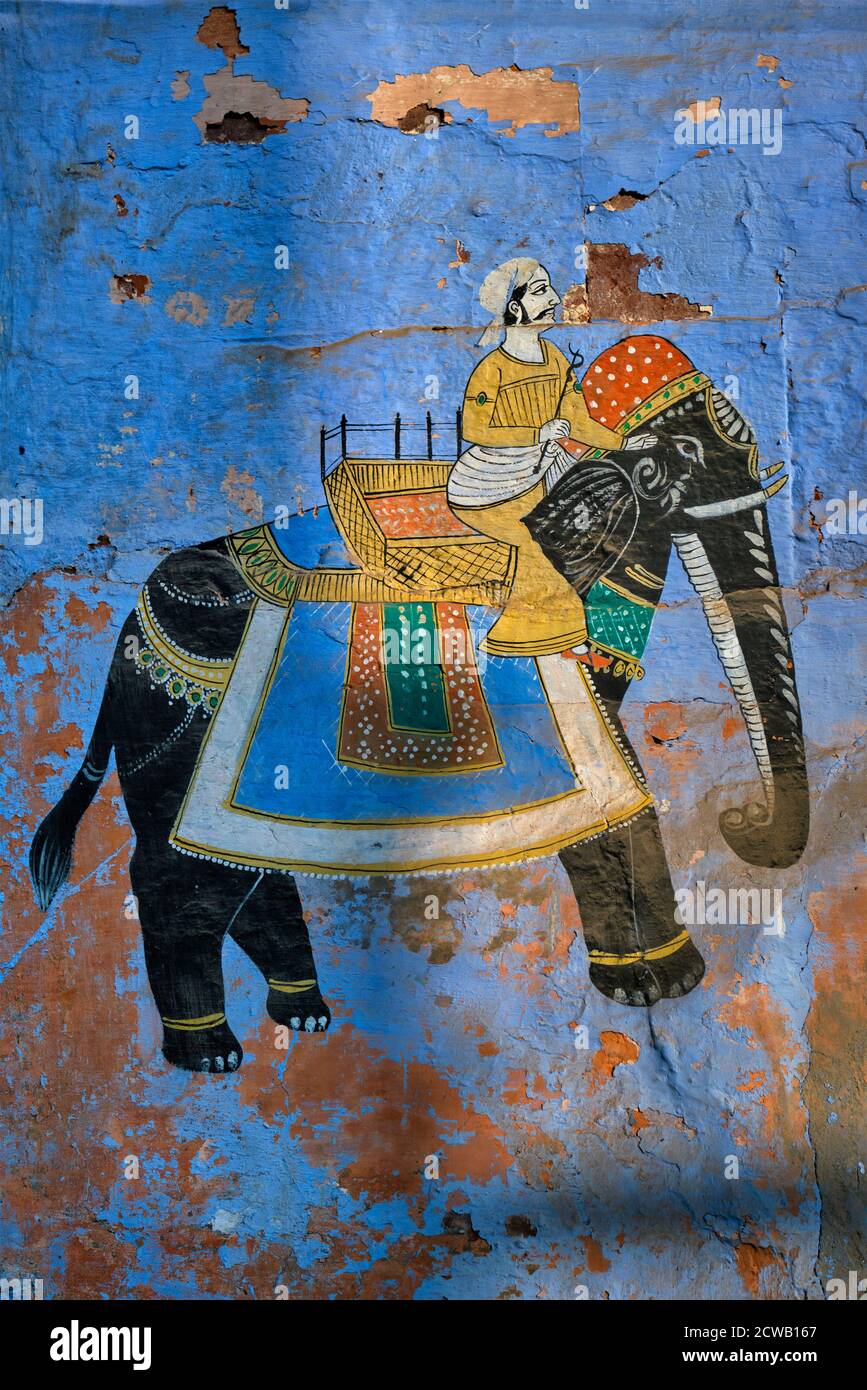 Mural of Maharajah on elephant on blue house wall in Jodhpur Stock Photo