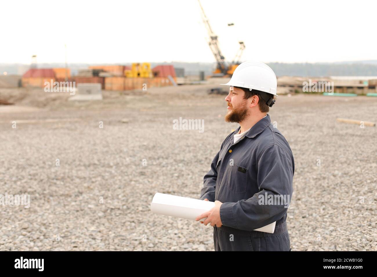 Caucasian american foreman holding blueprints papers on construction