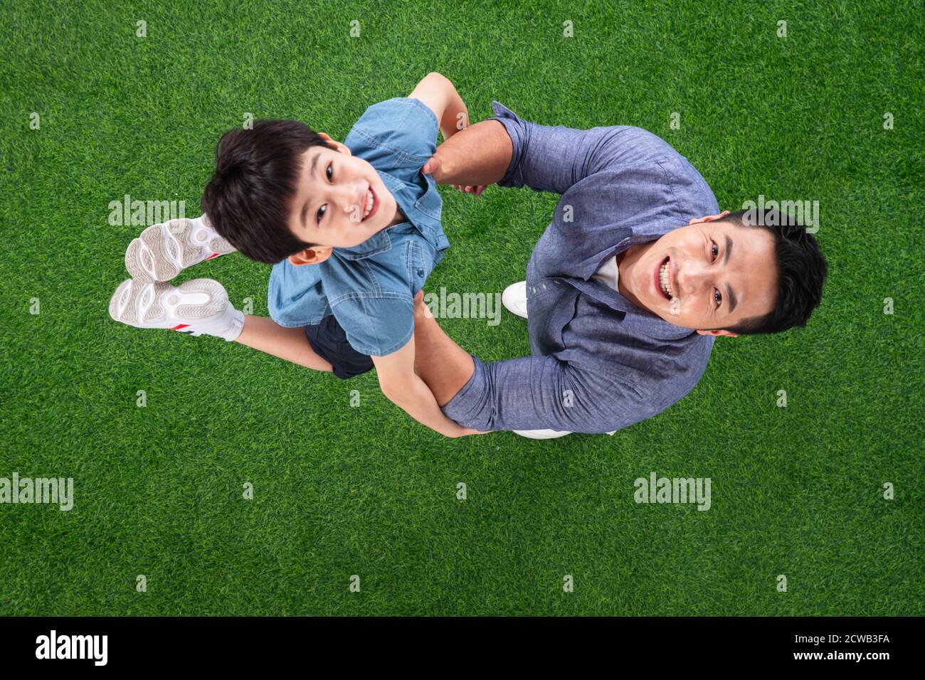 The happy father and son on the grass Stock Photo - Alamy