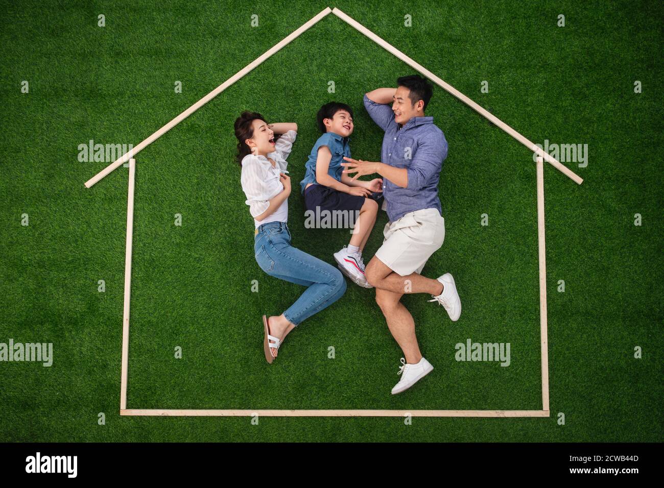 Happy house outline three lay on the grass Stock Photo