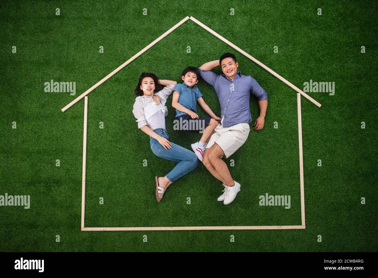 Happy house outline three lay on the grass Stock Photo