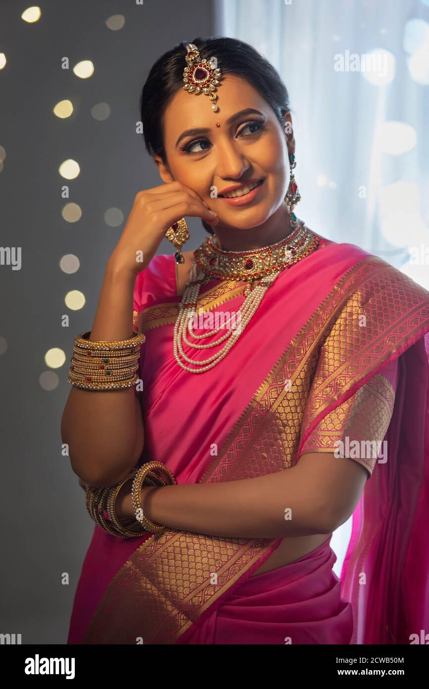Lady in a beautiful saree looking sideways while having a thought Stock Photo