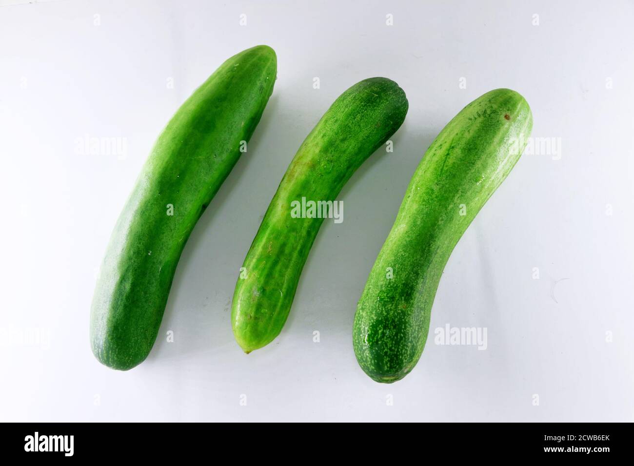 Three fresh cucumbers isolated on white Stock Photo