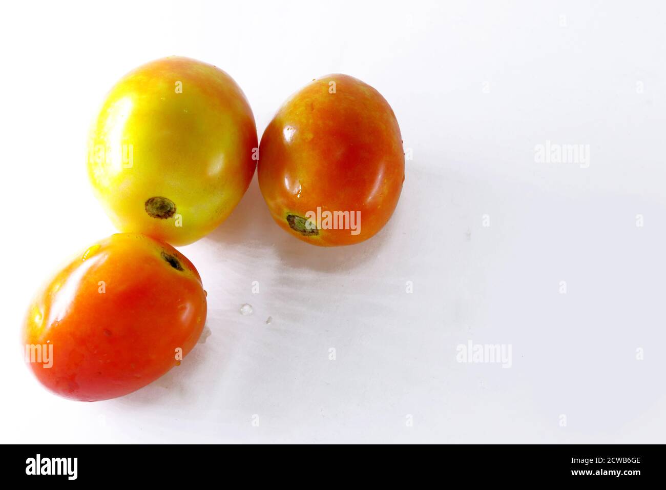 Three red Tomatoes isolated with white background Stock Photo - Alamy