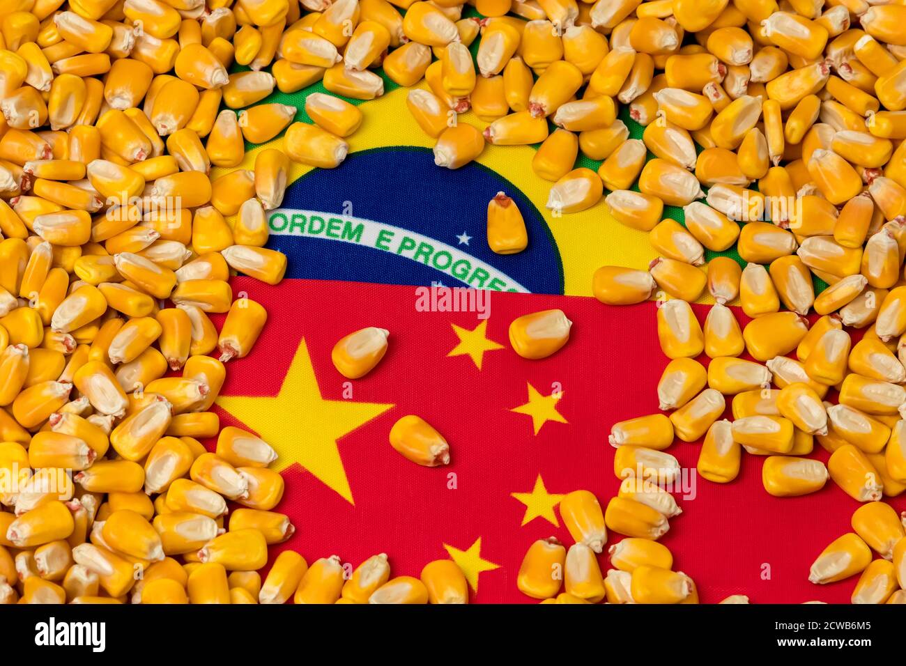 Flags of China and Brazil covered in corn kernels. Concept of Chinese and Brazilian agriculture imports, exports, trade war, agreement and tariffs. Stock Photo