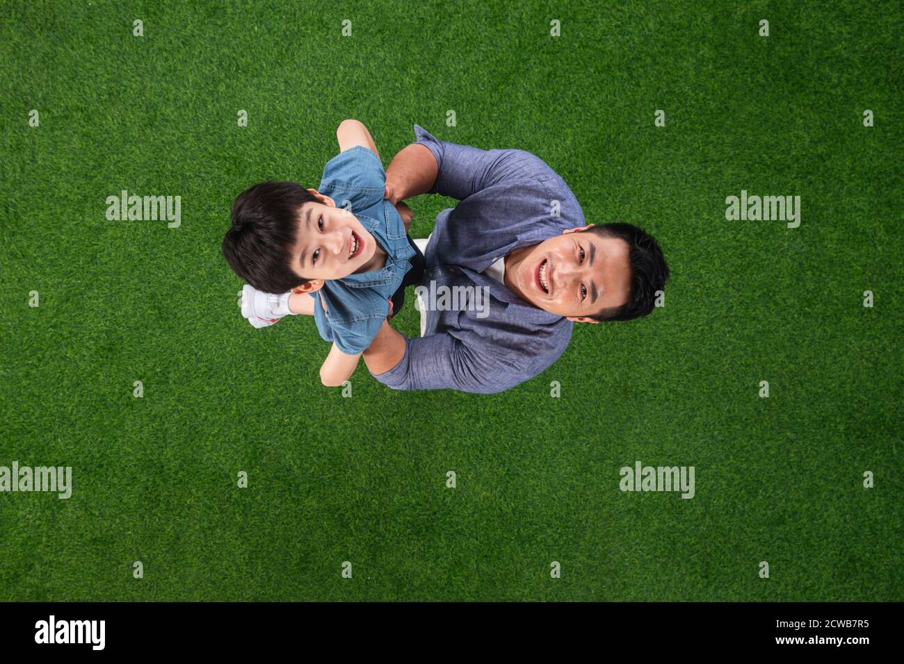 The happy father and son on the grass Stock Photo - Alamy