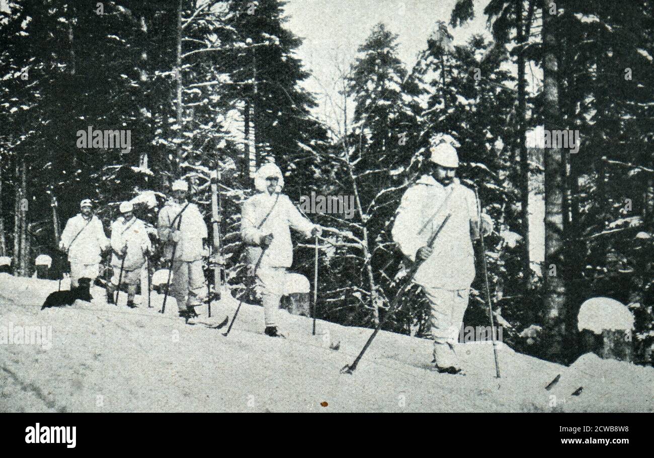 Austrian troops march through the snow in a pine forest. 1915. World War One Stock Photo