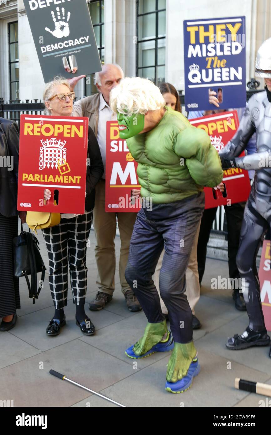 Robocop protester arrests another protester imitating Boris Johnson who compared himself to the Incredible Hulk throwing off the shackles of the EU. The protester was outside the Supreme Court in London during the hearing to challenge the Prorogation of Parliament. 17th Sept 2019.the prorogation of the Parliament, was ordered by Queen Elizabeth II upon the advice of the Conservative Prime Minister, Boris Johnson, on 28 August 2019. opposition politicians saw this as an unconstitutional attempt to reduce parliamentary scrutiny of the Government's Brexit plan. Stock Photo