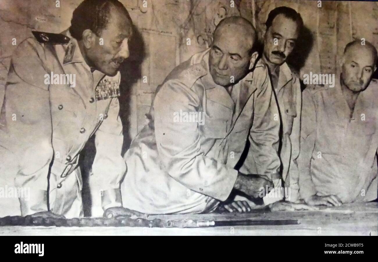 Photograph of President Anwar Sadat (1918-1981) with Lieutenant Major General Ahmad Asmail and El Gamasy. Stock Photo