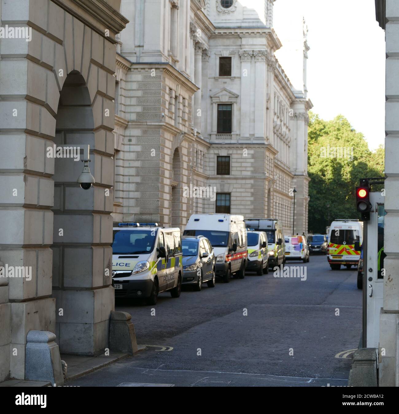 Police vans with Police reserves in Whitehall, London on standby during the 20th September 2019 climate strike, London. Also known as the Global Week for Future, a series of international strikes and protests to demand action be taken to address climate change. The 20 September protests were likely the largest climate strikes in world history. Organisers reported that over 4 million people participated in strikes worldwide, including 300000 people joined UK protests Stock Photo