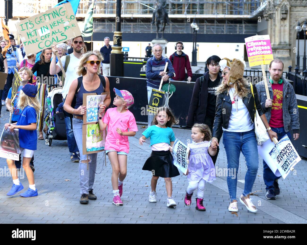 Families march past Parliament, London, during the 20th September 2019 climate strike. Also known as the Global Week for Future, a series of international strikes and protests to demand action be taken to address climate change. The 20 September protests were likely the largest climate strikes in world history. Organisers reported that over 4 million people participated in strikes worldwide, including 300000 people joined UK protests Stock Photo
