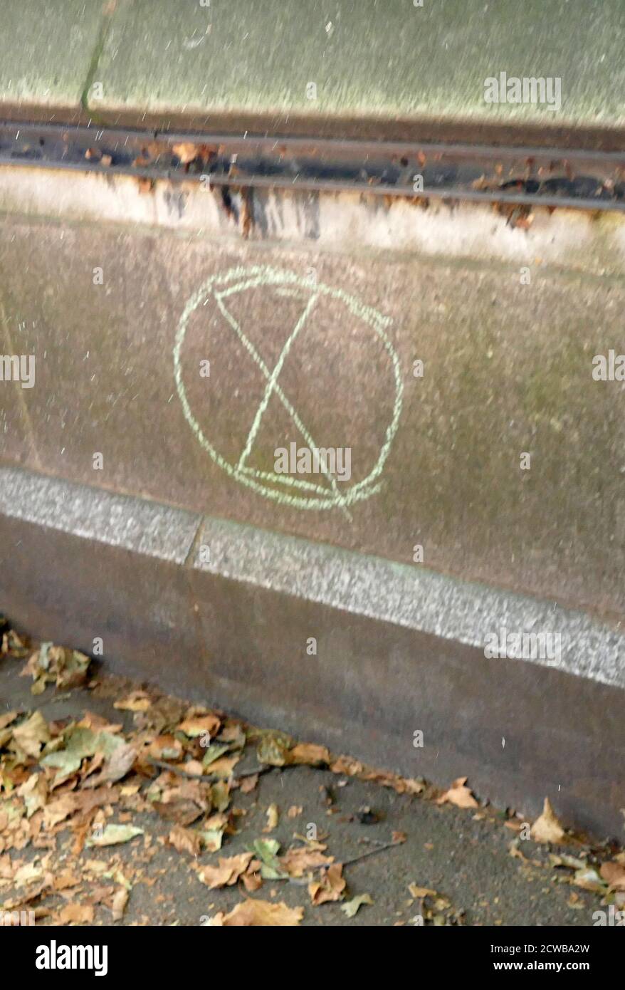 Extinction Rebellion logo on a wall, London, 2019. Extinction Rebellion is a political movement with the stated aim of using civil disobedience and nonviolent resistance to compel government action on climate breakdown, biodiversity loss, and the risk of social and ecological collapse. Extinction Rebellion was established in the United Kingdom in May 2018 with about one hundred academics signing a call to action in support in October 2018. In April 2019 Extinction Rebellion occupied 5 prominent sites in central London: Piccadilly Circus, Oxford Circus, Marble Arch, Waterloo Bridge and the area Stock Photo