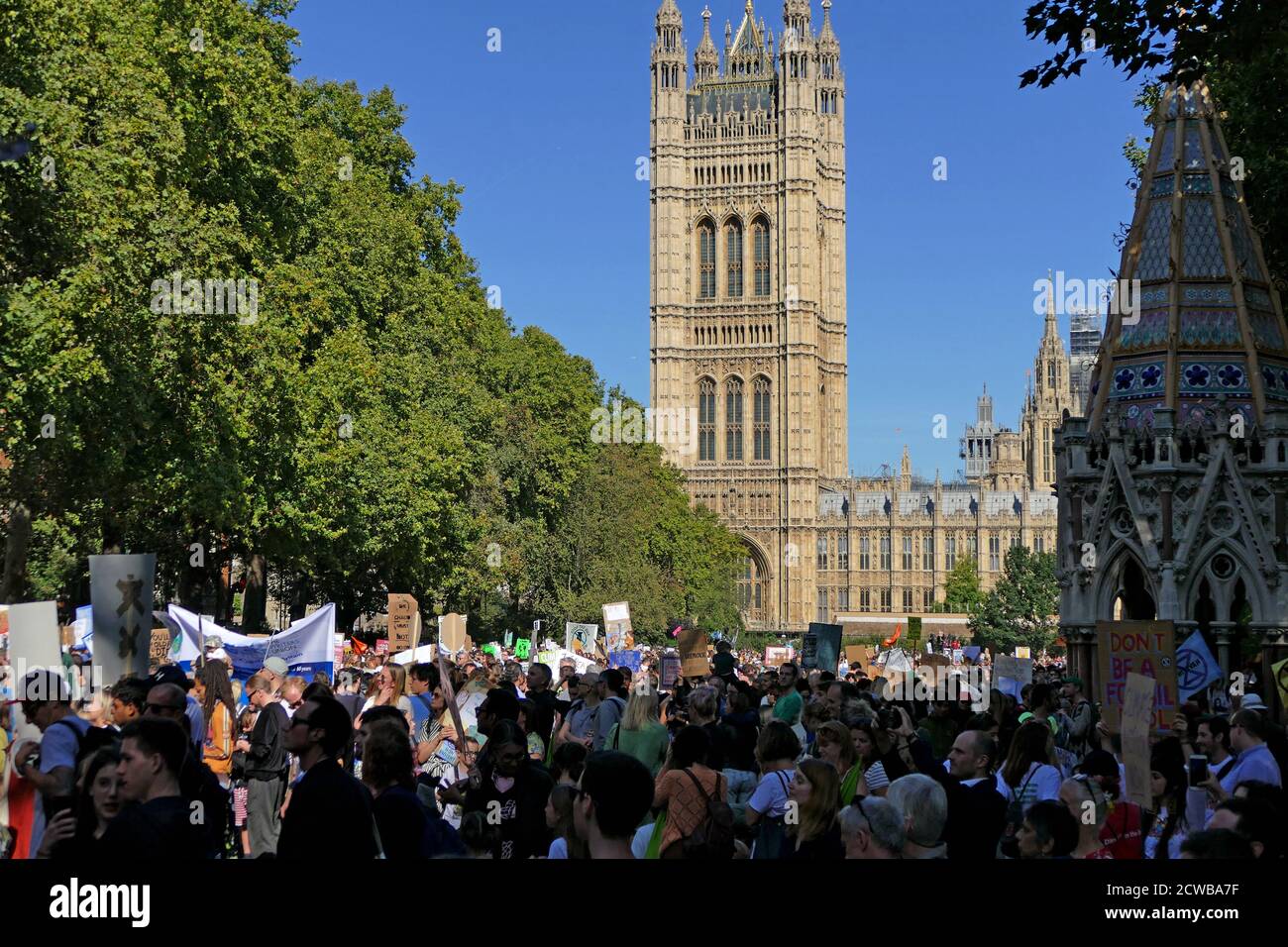 Protesters at a rally at Victoria Park, near Parliament, London, during the 20th September 2019 climate strike. Also known as the Global Week for Future, a series of international strikes and protests to demand action be taken to address climate change. The 20 September protests were likely the largest climate strikes in world history. Organisers reported that over 4 million people participated in strikes worldwide, including 300000 people joined UK protests. Greta Thunberg, (born 3 January 2003), Swedish environmental activist, credited with raising global awareness of the risks posed by clim Stock Photo