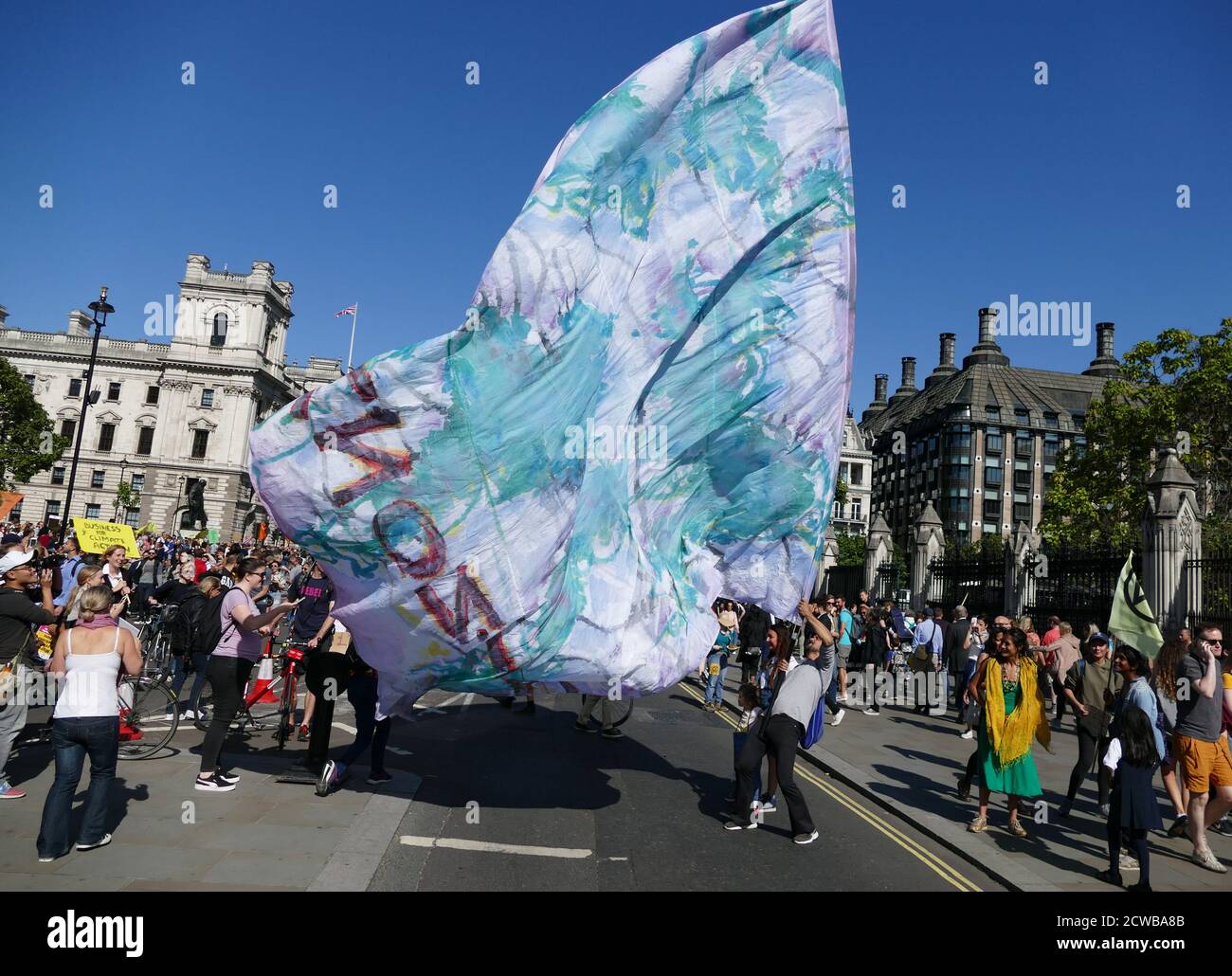 Protesters march near Parliament, London, during the 20th September 2019 climate strike. Also known as the Global Week for Future, a series of international strikes and protests to demand action be taken to address climate change. The 20 September protests were likely the largest climate strikes in world history. Organisers reported that over 4 million people participated in strikes worldwide, including 300000 people joined UK protests Stock Photo