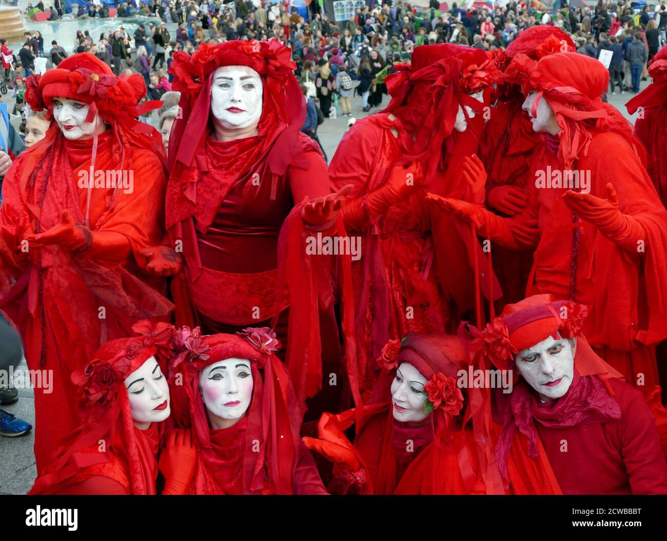 The Invisible Circus at the Extinction Rebellion protest 13th October 2019, at Trafalgar Square in central London . The Invisible Circus group from Bristol is made up of street performers dressed in red robes symbolizing the blood that binds humanity together. Stock Photo