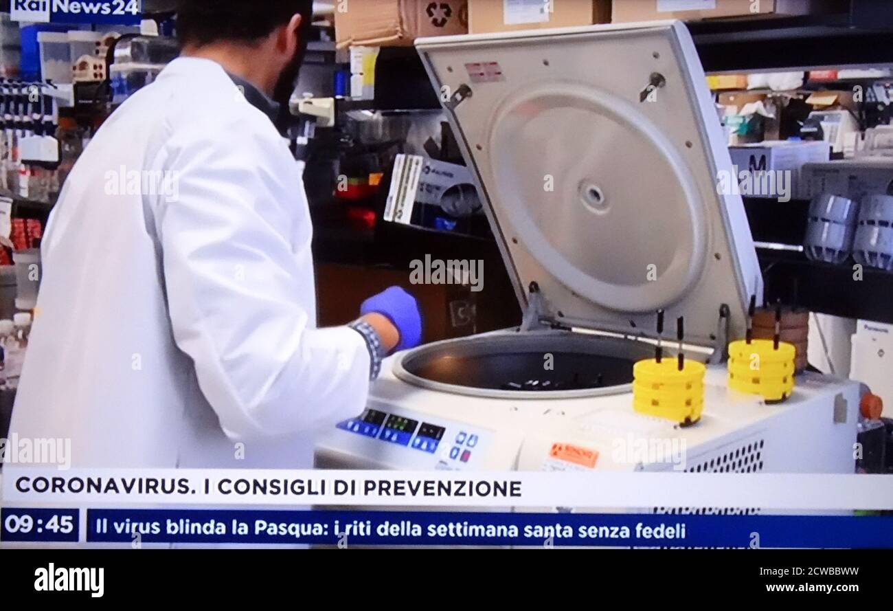 Italian TV highlights research by virologists into a vaccine during the COVID-19 pandemic. 14th March 2020 Stock Photo