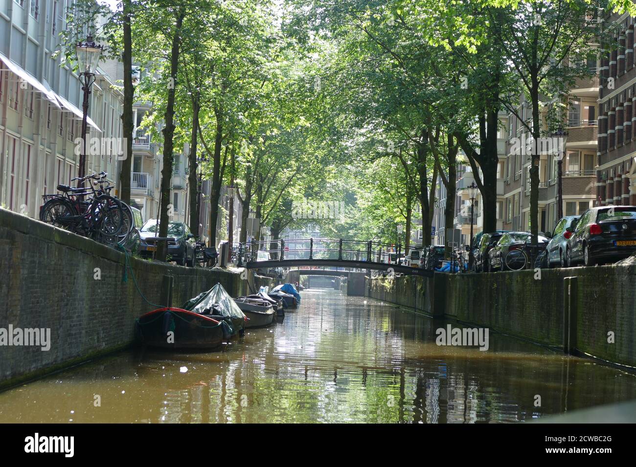 Canals in Amsterdam, Netherlands are used to transport people, tourists and supplies. Stock Photo