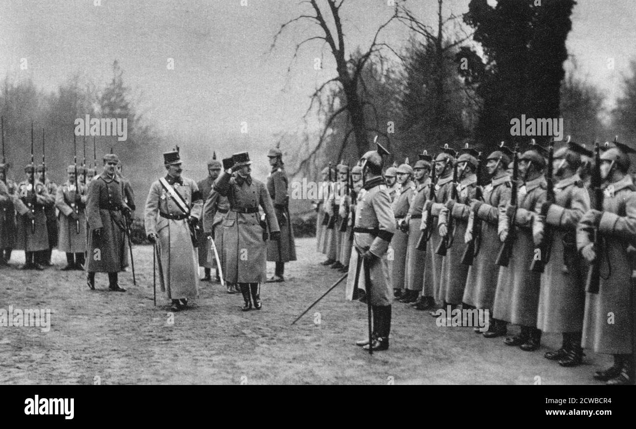 Emperor Karl I of Austria visiting Kaiser Wilhelm II at Army headquarters, World War I, 1917. Both Emperors salute the guard of honour in this photograph from Der Grosse Krieg in Bildern. The photographer is unknown. Stock Photo