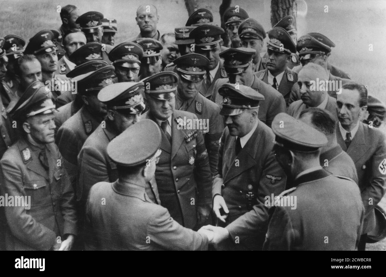 Adolf Hitler meeting with senior Nazis, Germany, August 1944. Hitler with reichsleiters and gauleiters (senior Nazi officials) after a meeting at his headquarters. The photograph was taken a month after the attempt on Hitler's life and Joseph Goebbels is on the right. The photographer is unknown. Stock Photo