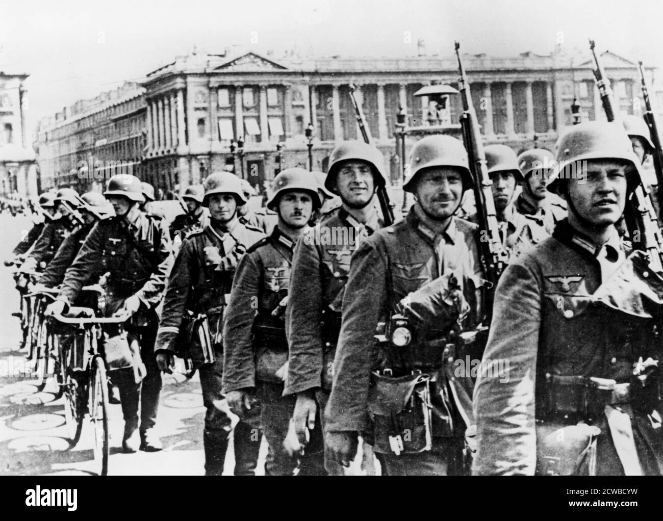 German troops marching through Paris, 17 June 1940. On 10 June the French government abandoned Paris, declaring it an open city, and the first German troops arrived four days later. The photographer is unknown. Stock Photo