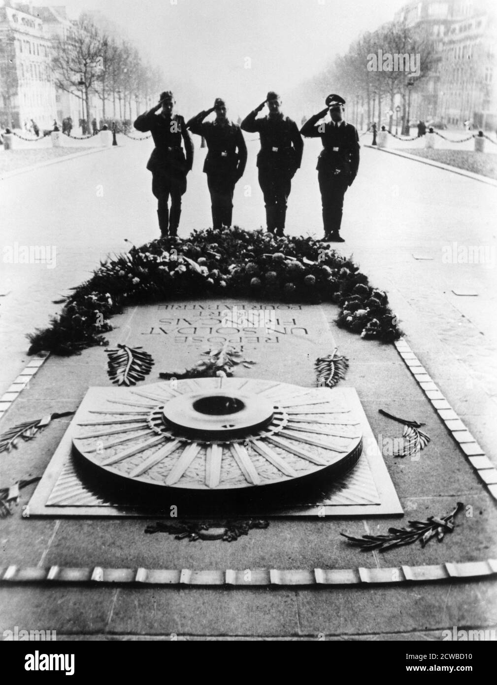 German soldiers saluting the Tomb of the Unknown Soldier at the Arc de Triomphe, Paris, December 1940. The photographer is unknown. Stock Photo