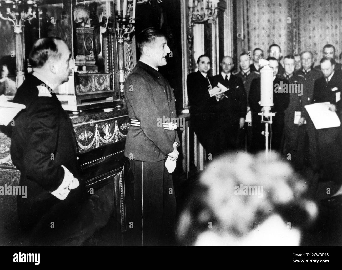 German Ambassador to Vichy France, Otto Abetz, delivering a press conference, 15 December 1940. The subject was the transfer of the body of the Emperor Napoleon II from Vienna to Paris, a gift from Hitler to the Vichy regime. On the left is Fernand de Brinon, a leading French collaborator during the Nazi occupation who was tried as a war criminal by the French after the liberation and executed in 1947. The photographer is unknown. Stock Photo