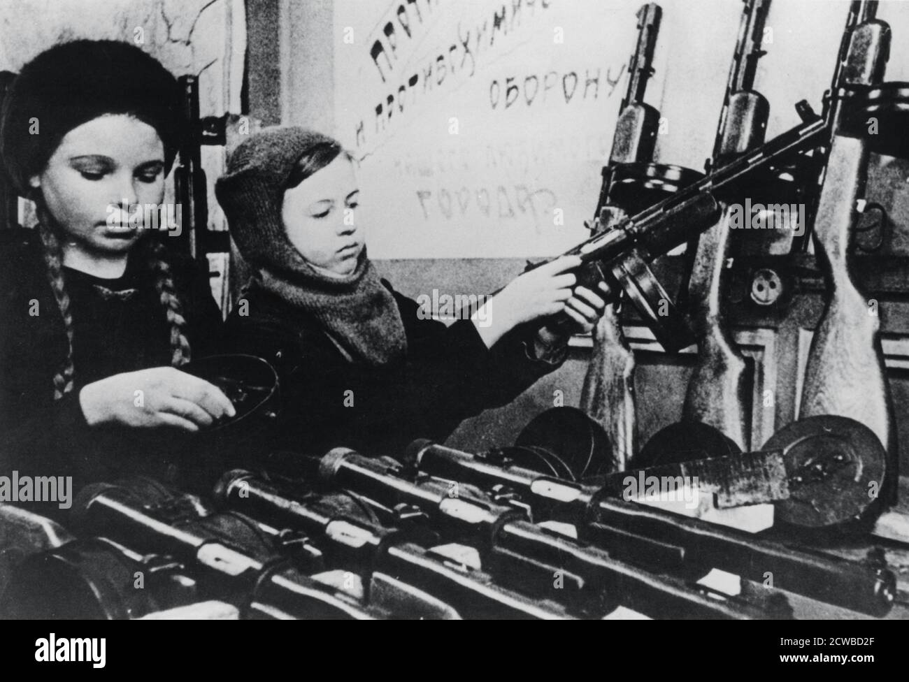 Young girls assembling machine guns in a Russian factory, 1943. The photographer is unknown. Stock Photo