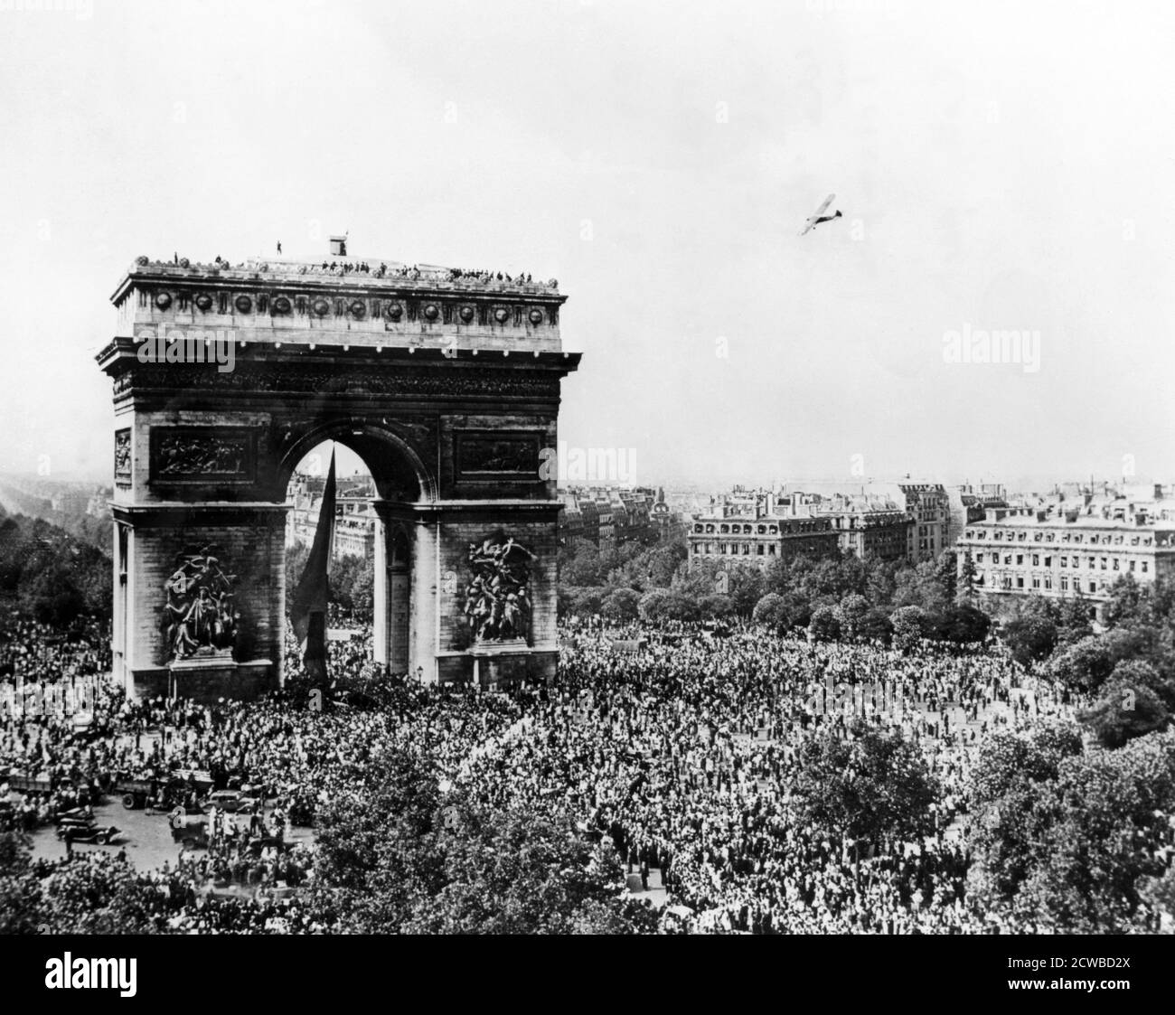 Celebrating the liberation of Paris, 26 August 1944. Crowds gathered around the Arc de Triomphe the day after the German forces in the city surrendered to the Allies. The photographer is unknown. Stock Photo