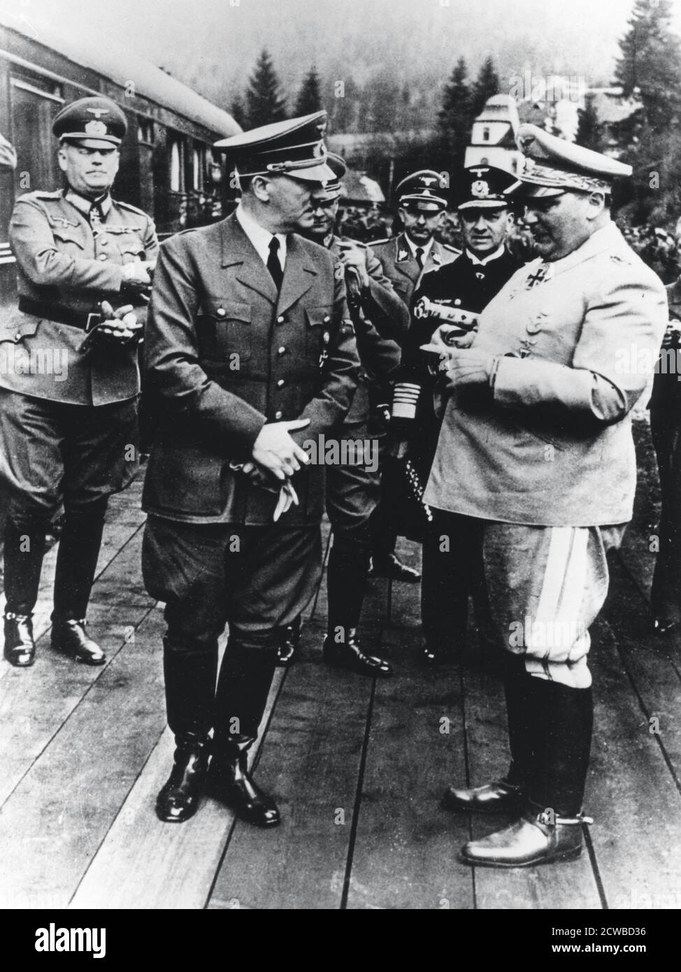 Adolf Hitler and Hermann Goering, Nazi leaders, Germany, 20 April 1941. Hitler, Goering and other senior Nazis at the fuhrer's headquarters on his 52nd birthday. Field Marshal Wilhelm Keitel is to the left of Hitler and Admiral Erich Raeder, commander of the German navy, immediately to the left of Goering. The photographer is unknown. Stock Photo