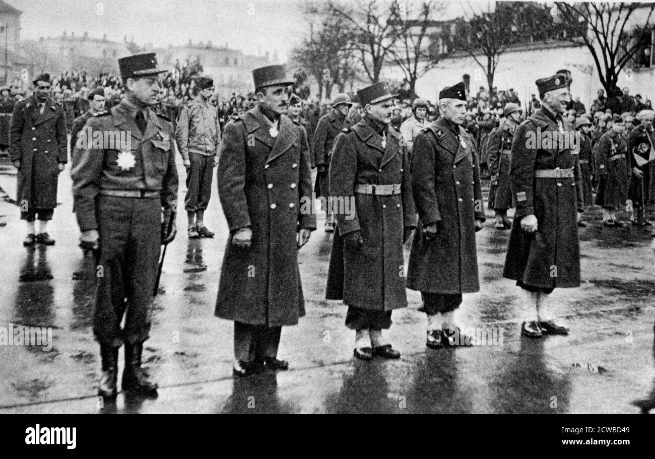 French soldiers being awarded the Legion d'Honneur, Mulhouse, France, 10 February 1945. Troops receiving decorations from General de Gaulle. The soldier on the left of the front row is General Bethouard, commander of the French 1st Army Corps and a Grand Officer in the Legion. The photographer is unknown. Stock Photo